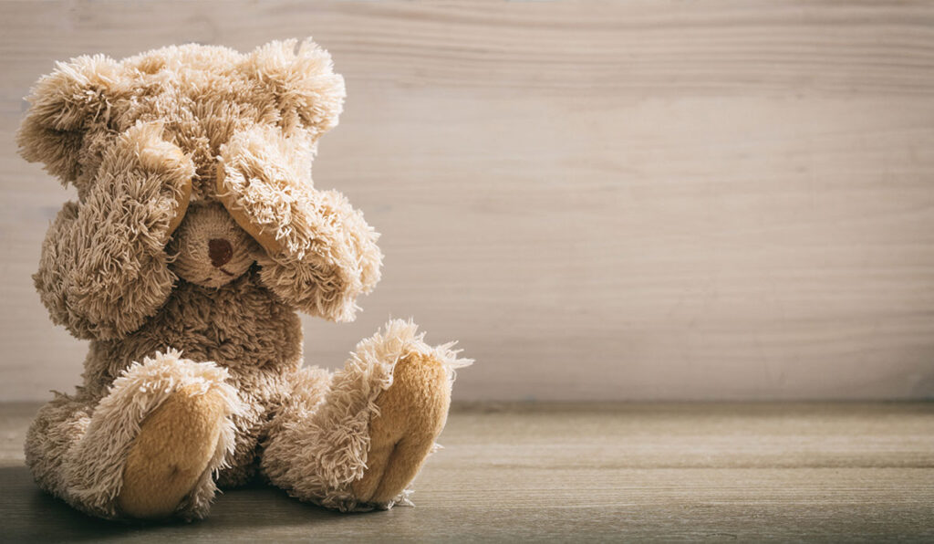 teddy bear covering eyes